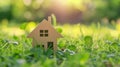 Little toy model house in large grass meadow field. eco friendly concept Royalty Free Stock Photo