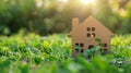 Little toy model house in large grass meadow field. eco friendly concept Royalty Free Stock Photo