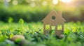 Little toy model house in large grass meadow field. eco friendly concept Royalty Free Stock Photo