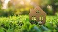 Little toy model house in large grass meadow field. eco friendly concept Royalty Free Stock Photo