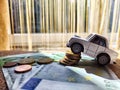 Little toy white car and euro money. Concept of the expensiveness of buying a new car, affordability of buying an old