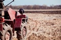 Little tractor a field in the spring