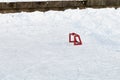 Little training red hockey goal on ice rink in the park. Active winter outdoor games