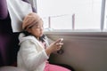 Little traveler play mobile phone in train