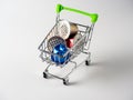 Little trolley with used aluminum coffee capsules isolated on a white background. A concept for processing raw materials and