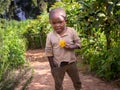 A little ugandan boy with a flower in his hand