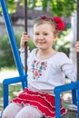 Little ukrainian child girl having fun on a swing