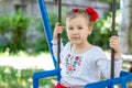 Little ukrainian child girl having fun on a swing