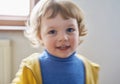 Little Ukrainian child smiling. He is wearing blue and yellow clothes