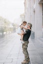 Little Ukrainian girl meets her father from the war during his vacation and joyful embraces him Royalty Free Stock Photo