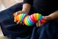 Little unrecognizable girl plays with new trendy plastic toy slug,antistress fidget for kids and adults,motor skills