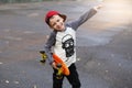 Little urban boy with a penny skateboard. Young kid riding in th Royalty Free Stock Photo