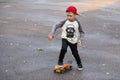 Little urban boy with a penny skateboard. Young kid riding in th Royalty Free Stock Photo