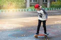 Little urban boy with a penny skateboard. Young kid riding in th Royalty Free Stock Photo