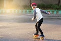 Little urban boy with a penny skateboard. Young kid riding in th Royalty Free Stock Photo