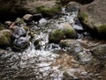 Little Waterfall Between Boulders and Rocks on a Stream Royalty Free Stock Photo