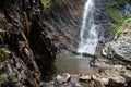 Little waterfall and geological mountain folds in the mountains