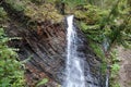 Little waterfall and geological mountain folds in the mountains