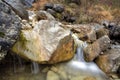 Little waterfall with rannig water in rocks Royalty Free Stock Photo