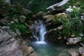 Little waterfall among the rocks in mountain forest Royalty Free Stock Photo