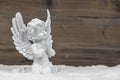 Little white angel ion wooden background Royalty Free Stock Photo