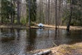 A little white boat upsidedown on land