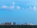 Little white clouds in blue dusk sky over city Royalty Free Stock Photo