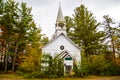 A little white country church in the beginnings of fall colors Royalty Free Stock Photo