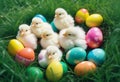 Little white Easter chicks nestled among colorful painted Easter eggs Royalty Free Stock Photo