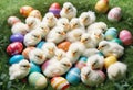 Little white Easter chicks nestled among colorful painted Easter eggs Royalty Free Stock Photo
