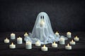 Little white ghost with burning candles. Royalty Free Stock Photo