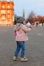 little white girl drinks milkshake on the street in the evening. Portrait on the background of the sunset cityscape Royalty Free Stock Photo