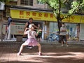 GUANGZHOU, CHINA - CIRCA MAY 2020: A little white girl practises kung-fu with a Chinese martial arts teacher