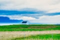 A little a little white house in a field on the prairie, clouds in the b house in a field on the prairie, clouds in the background Royalty Free Stock Photo