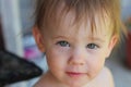 little white pensive child with tousled hair without clothing