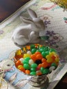 Jelly beans and a small white porcelain rabbit helps set a sweet Easter Royalty Free Stock Photo