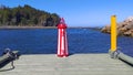 Miniature reproduction of white and red lighthouse on a pier at the St Lawrence river GaspÃÂ©sie QuÃÂ©bec Canada Royalty Free Stock Photo