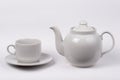 Little white tea cup and a kettle Royalty Free Stock Photo