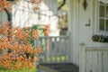 little white wooden summer house in the garden with green grass and trees at the background Royalty Free Stock Photo