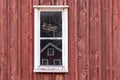 A little window in front of a typival scandinavian building with falu red Royalty Free Stock Photo