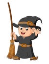 The little witch boy is holding the magic broom Royalty Free Stock Photo