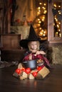 Little witch in costum and hats conjure pot, childhood hallowee Royalty Free Stock Photo