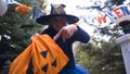 Little witch kid demanding sweets, children trick-or-treating, Halloween event