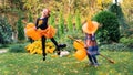 Little witch learns to fly on a broomstick at halloween party. Happy girls dressed as sorceresses are jumping on a broom with Royalty Free Stock Photo