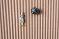 Little woman figurine on paper beside a marble