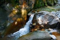 Little wondrous waterfall among the rocks in mountain forest Royalty Free Stock Photo