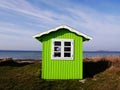 A little wooden beach hut painted bright green, Aero Island, Denmark Royalty Free Stock Photo