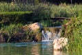 Little wooden bridge and waterfall in a garden Royalty Free Stock Photo