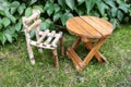 Little wooden chair and small round table on green grass Royalty Free Stock Photo