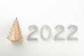 Little wooden Christmas tree with 2022 numbers on light background. Copy space. Royalty Free Stock Photo